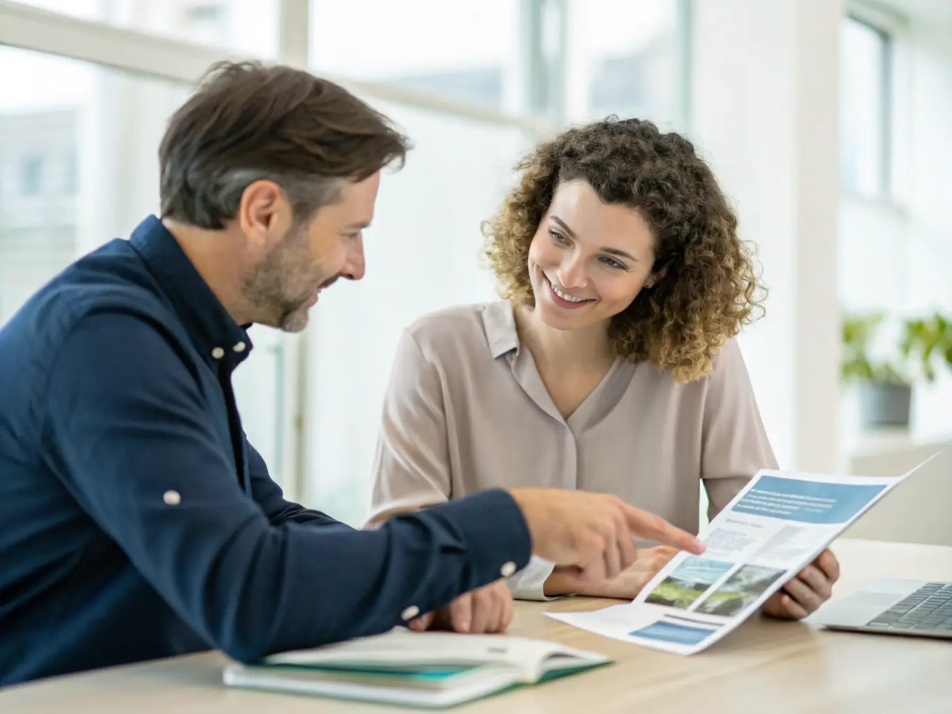 A friendly Peak Solar consultant discussing solar options with a homeowner in their living room, emphasizing personalized service and a comfortable environment.
